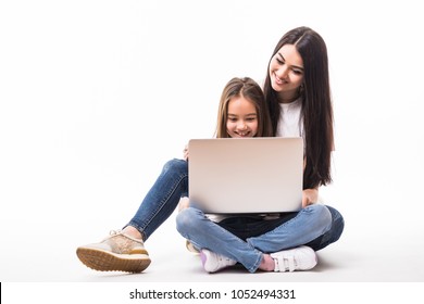 Mother And Child With Laptop Computer Lying On The Floor, Isolated On White