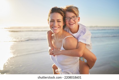 Mother And Child On Beach With Sunshine, Ocean Waves For Summer Holiday With Kid Wellness, Love And Care. Happy, Mom Playing With Disability Kid Support Piggyback Ride And Vacation Outdoor Portrait