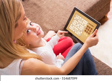 Mother And Child Playing Sudoku Together