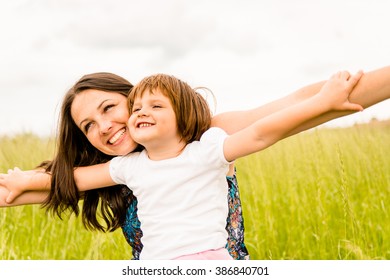 Mother And Child Pretend With Hands They Are Together Flying