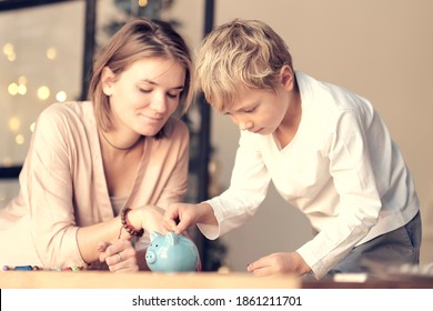 Mother And Child Putting Coin Into Piggy Bank. Education Of Children In Financial Literacy. Money, Cash, Investment.