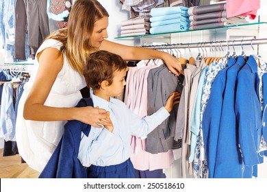 Mother With Child Searches Clothes While  Shopping