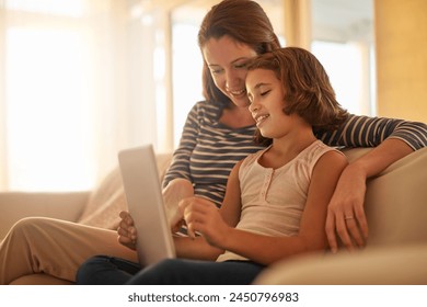 Mother, child and sofa with tablet for streaming movies, happiness and bonding together in living room. Family, mom and young girl with technology for e learning, education or social media in home - Powered by Shutterstock