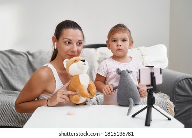 Mother With Child Streaming Online Video Of Unboxing Clothes. Influencer Occupation, Mommy Blog