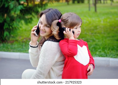 Mother And Child Talking On The Phone