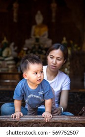 Mother And Child In Thai Buddhist Temple