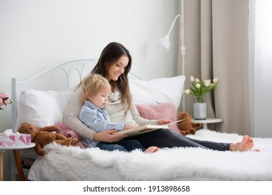 Mother And Child, Toddler Boy, Reading Book In Bed, Daytime