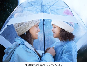 Mother, child and umbrella for bonding in rain, outdoor and protection or insurance for cold weather. Mommy, daughter and winter season for love in relationship, profile and holiday for happiness - Powered by Shutterstock