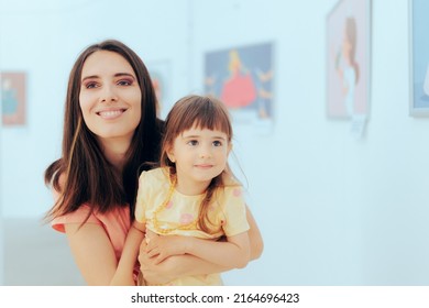 
Mother and Child Visiting an Exhibition of Illustrations . Cute daughter and her mother learning more about modern art
