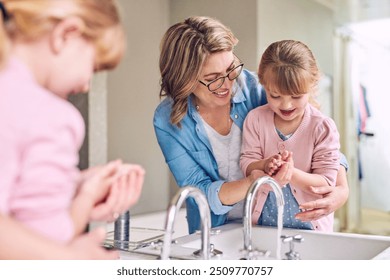 Mother, child and washing hands in bathroom for cleaning, help and learning. Mom, young girl and hygiene at home with soap, foam bubbles and support in family with care and development for growth - Powered by Shutterstock