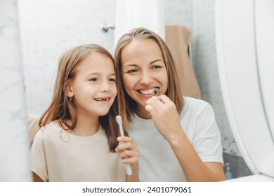 Mother and children brush their teeth in the bathroom. - Powered by Shutterstock