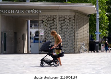 Mother With Children In Children's Push Chair On Sechseläuten Square At City Of Zürich On A Sunny Summer Day. Photo Taken June 8th, 2022, Zurich, Switzerland.