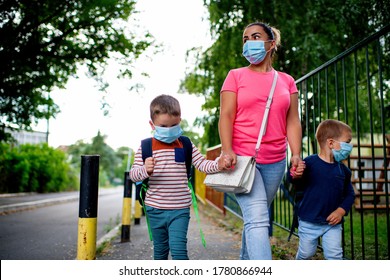 Mother And Children Going To Preschool During Corona Virus. Surgical Mask For Illness Prevention.