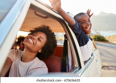 Mother And Children Relaxing In Car During Road Trip