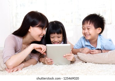 mother and children using tablet computer - Powered by Shutterstock