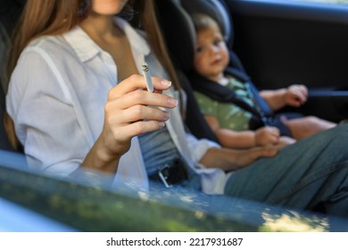 Mother With Cigarette And Child In Car, Closeup. Don't Smoke Near Kids