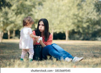 Mother Cleaning Her Daughter Hands With Antibacterial Wipes. Overprotective Mom Cleaning Toddlers Hands After Playing 
