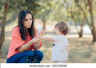 Mother Cleaning Her Daughter Hands With Antibacterial Wipes. Overprotective Mom Cleaning Toddlers Hands After Playing 
