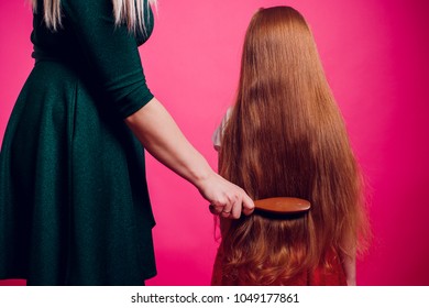 Mother Combing Daughter, Care About Hairstyle. Girl Is Unhappy Mom Pulling Her Hair. Important Role In Child Life.