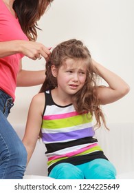 Mother Combing Daughter, Care About Hairstyle. Girl Is Unhappy Mom Pulling Her Hair. Important Role In Child Life.