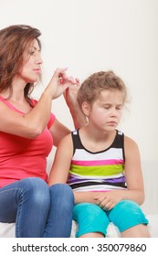 Mother Combing Daughter, Care About Hairstyle. Girl Is Unhappy Mom Pulling Her Hair. Important Role In Child Life.