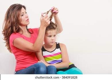 Mother Combing Daughter, Care About Hairstyle. Girl Is Unhappy Mom Pulling Her Hair. Important Role In Child Life.