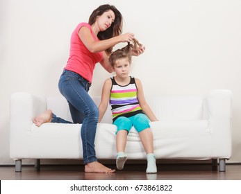 Mother Combing Daughter, Care About Hairstyle. Girl Is Unhappy Mom Pulling Her Hair. Important Role In Child Life.