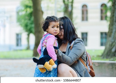 Mother Comforting Crying Daughter After He Injured. Mom Hug Her Three Year Old Sweet Toddler Girl. Motherhood, Childhood And Protection Concept.