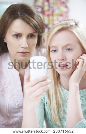 Mother Comforting Daughter Being Bullied By Text Message