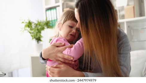 Mother consoles crying baby girl. Parenthood and family support concept - Powered by Shutterstock