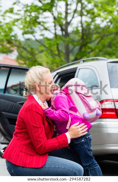 Mother consoling daughter on
first day at school, the kid being a bit afraid of what may lay
ahead