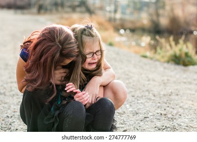 Mother consoling her hurt daughter at a park in Reno, Nevada, USA.