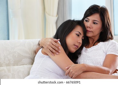 Mother Consoling Her Sad Daughter Who Has Problem