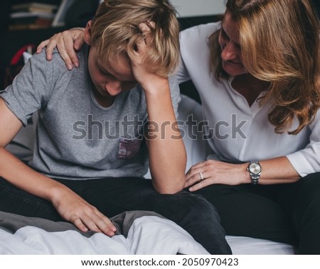 Mother consoling her upset son