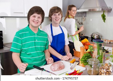 Mother cooking with her sons in the kitchen - family life.