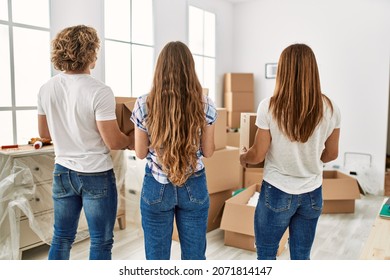 Mother And Couple On Back View Holding Packages At Home