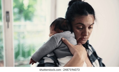 Mother cradling her newborn baby on her shoulder after breastfeeding, capturing a quiet moment of bonding and care in a sunlit room. baby rests peacefully on the mother - Powered by Shutterstock