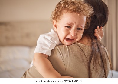 Mother And Crying Baby In A Bedroom With Portrait Of Sad Son Looking Upset At Nap Time. Children, Love And Insomnia With Baby Boy Comfort By Loving Parent, Embracing And Bond In Their Home Together