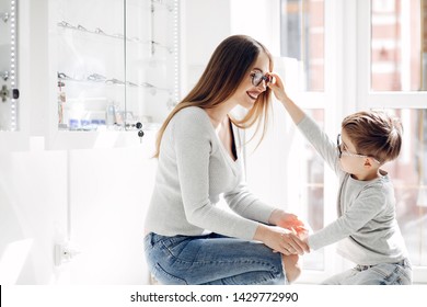 Mother With Cute Son. Family Buy Glasses