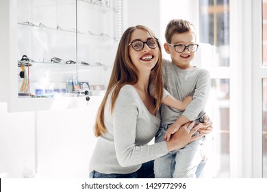 Mother With Cute Son. Family Buy Glasses