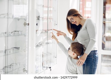 Mother With Cute Son. Family Buy Glasses