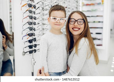 Mother With Cute Son. Family Buy Glasses