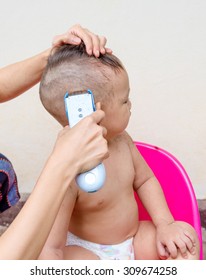 Mother Cutting Baby Hair By  Clipper