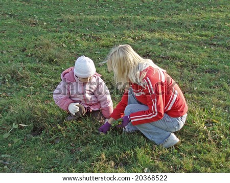 Similar – Image, Stock Photo Little girl putting apple inside of wicker basket