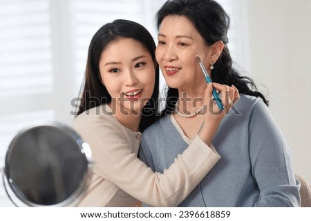 Mother and daughter applying mothers day women mother