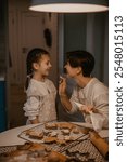 mother and daughter baking christmas cookies