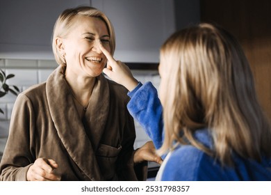 Mother and daughter baking Christmas cookies together, holiday traditions, family bonding, festive kitchen, creating memories, holiday spirit, Christmas preparation. - Powered by Shutterstock