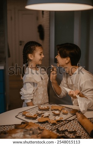 mother and daughter baking christmas cookies