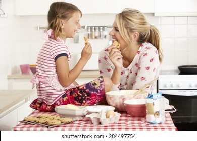 Mother And Daughter Baking In Kitchen