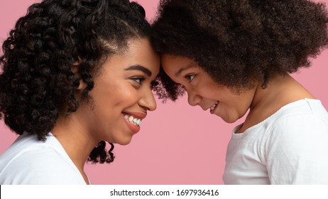 Mother Daughter Bonding. Side View Portrait Of Cute Black Girl And Her Smiling Mom Touching Foreheads And Looking To Each Other's Eyes, Panorama